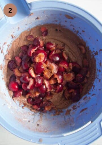 adding fresh chopped cherries to muffin batter in a bowl.