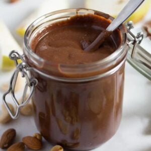 chocolate peanut butter spread in a jar with a spoon in it.