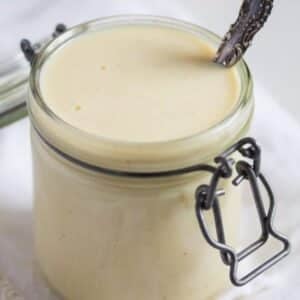 german vanilla sauce in a jar with a serving spoon in it.