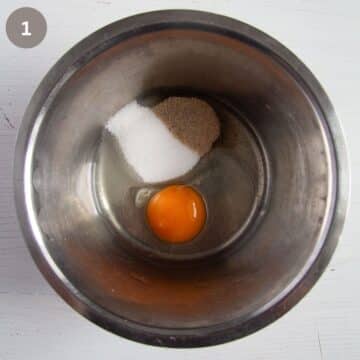 eggs, sugar, vanilla in a small metal bowl.