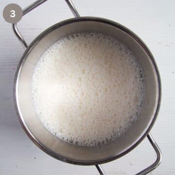 frothy milk in a saucepan.