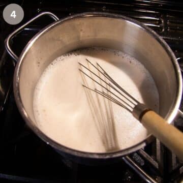 whisking vanilla sauce in a pan.