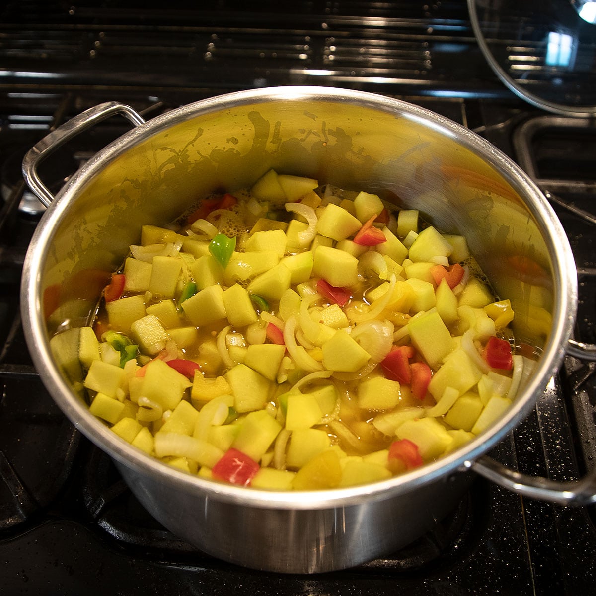 zucchini pickles cooking in a large pot.