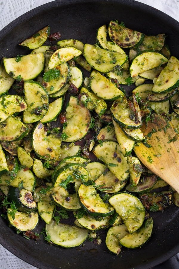 zucchini with pesto in a pan