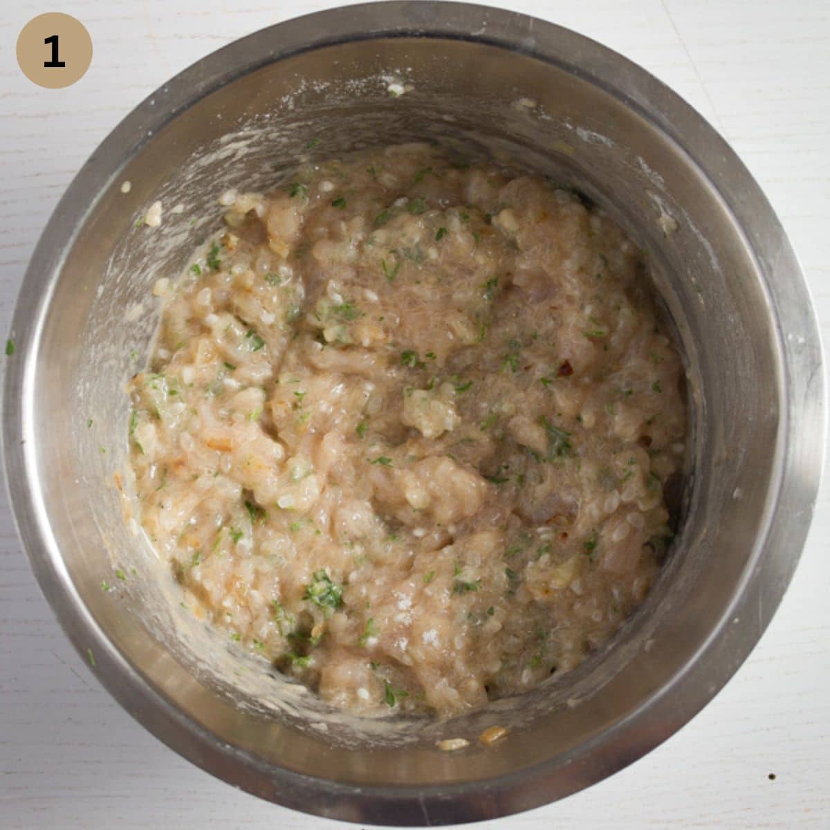 mixture for making chicken meatballs in a bowl.