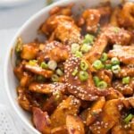 spicy korean chicken strips with green onions and sesame.