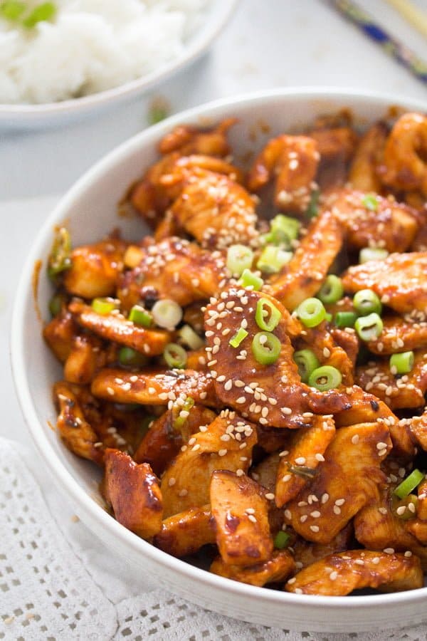 spicy korean chicken strips with green onions and sesame.