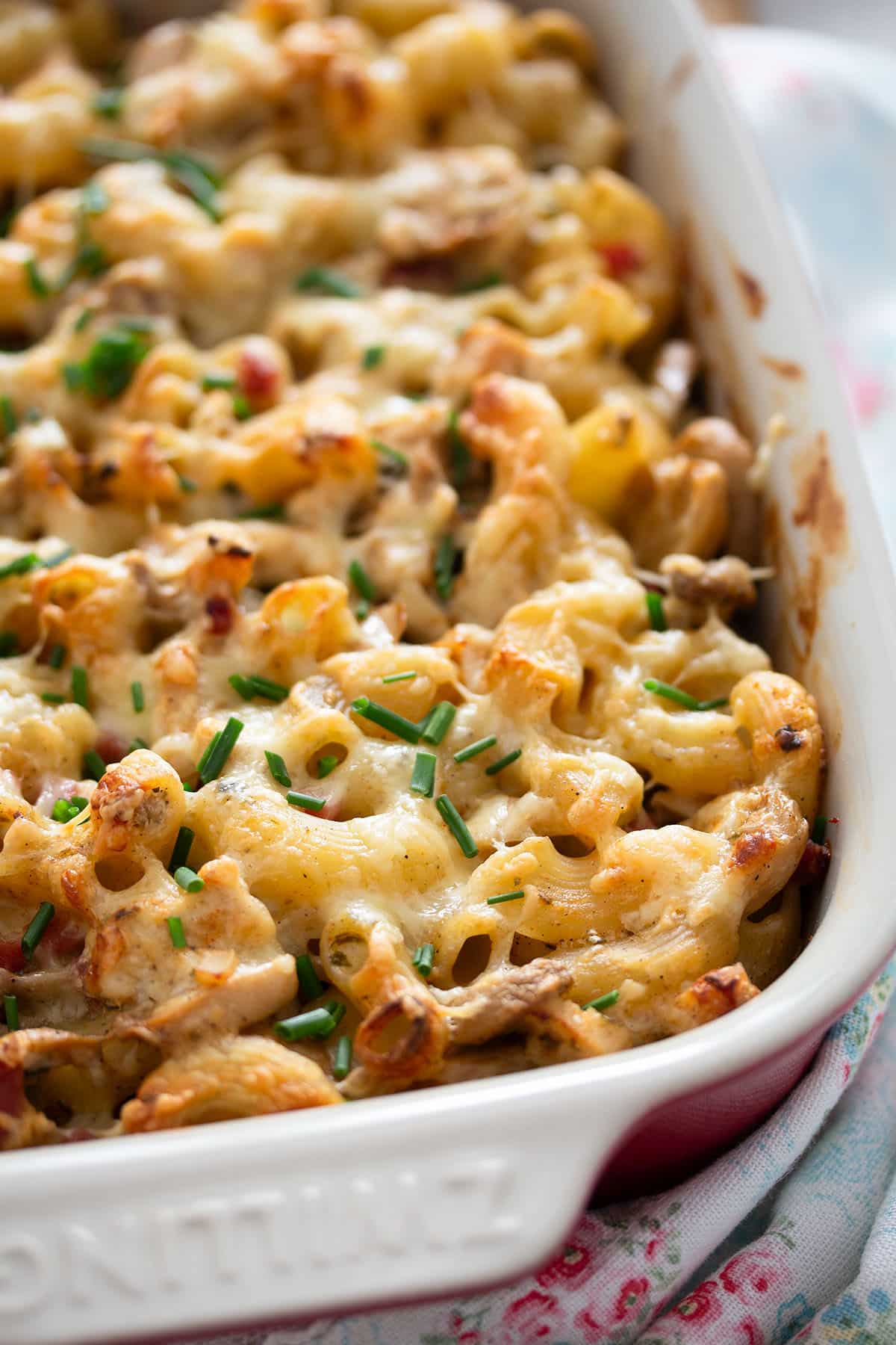 casserole dish full of baked pasta with leftover chicken and cheese.