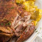 easter lamb with potatoes on a white platter