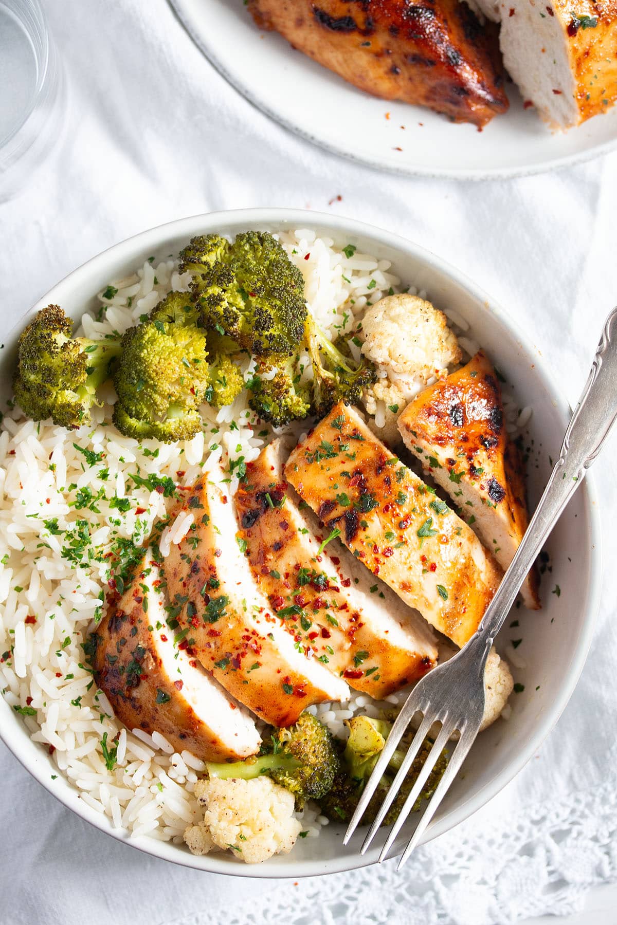 bowl with sliced chicken breast, broccoli and rice.