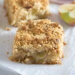 one square piece of german apple crumble cake and half an apple.