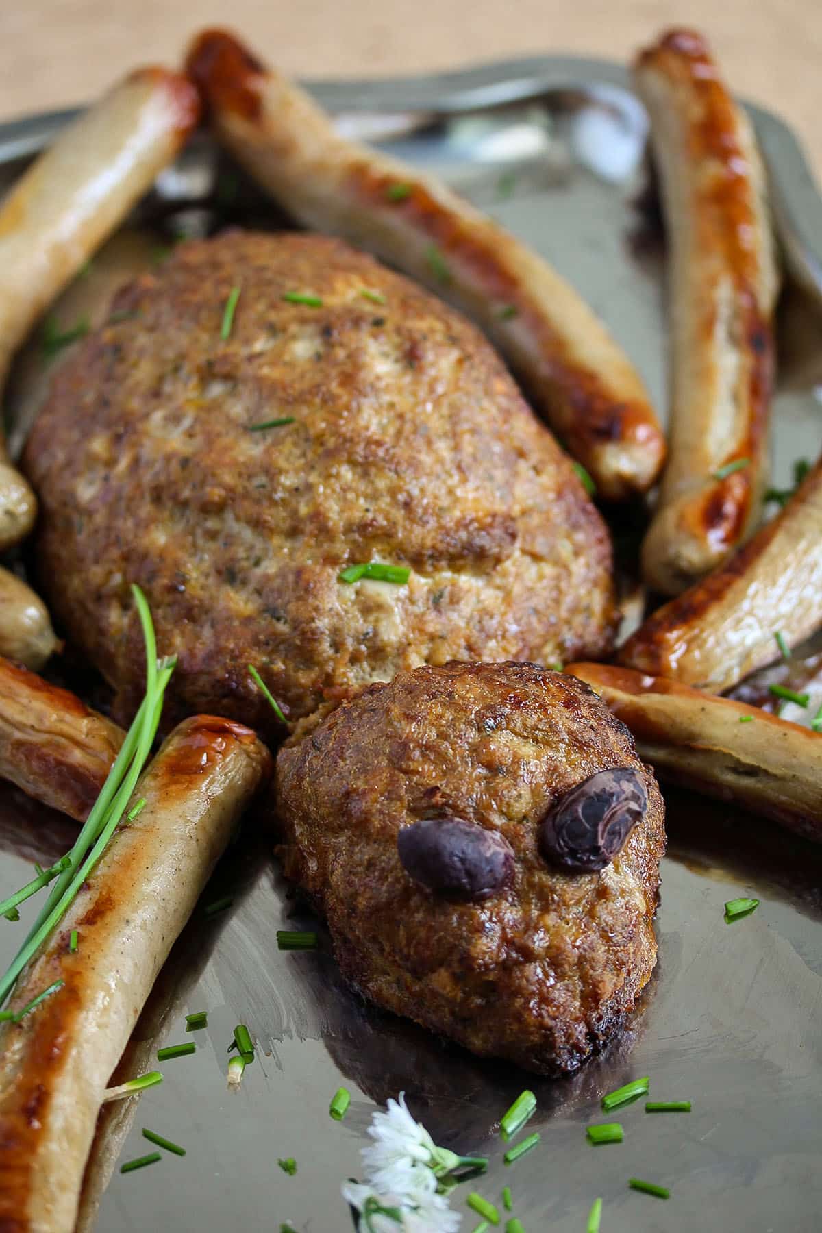 halloween spider meatloaf with olive eyes and sausage legs.