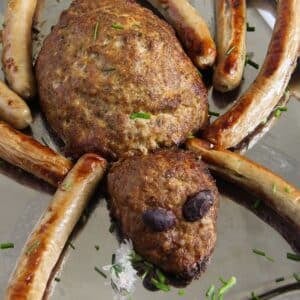 halloween spider meatloaf idea with sausage legs on a platter.