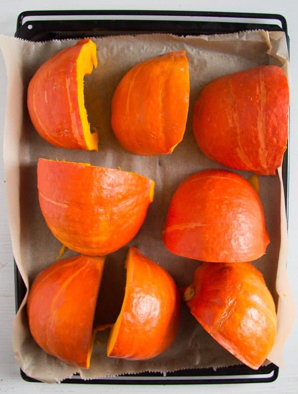 pumpkin pieces on a baking tray