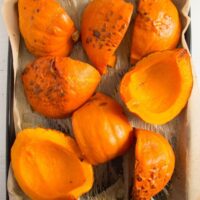roasted pumpkin pieces on a baking tray
