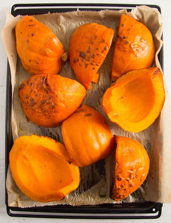 roasted pumpkin pieces on a baking tray