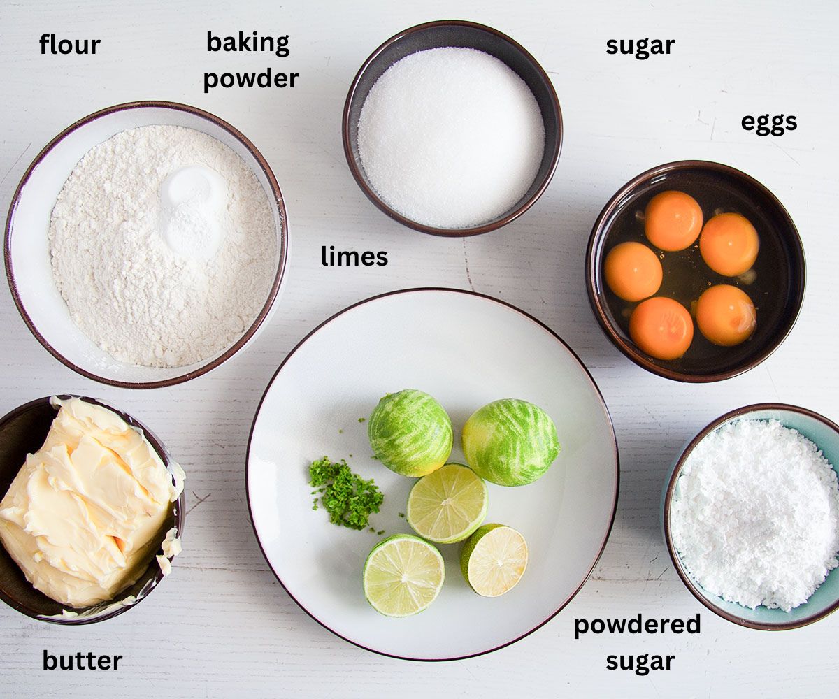 listed ingredients for making lime cake with lime juice drizzle on the table.