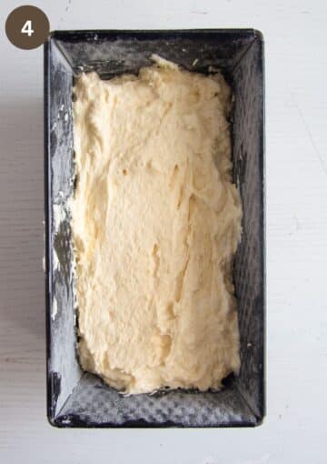 unbaked cake batter in a buttered loaf tin.