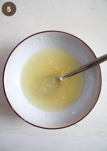 mixing lime juice and powdered sugar to make drizzle for cake in a bowl.