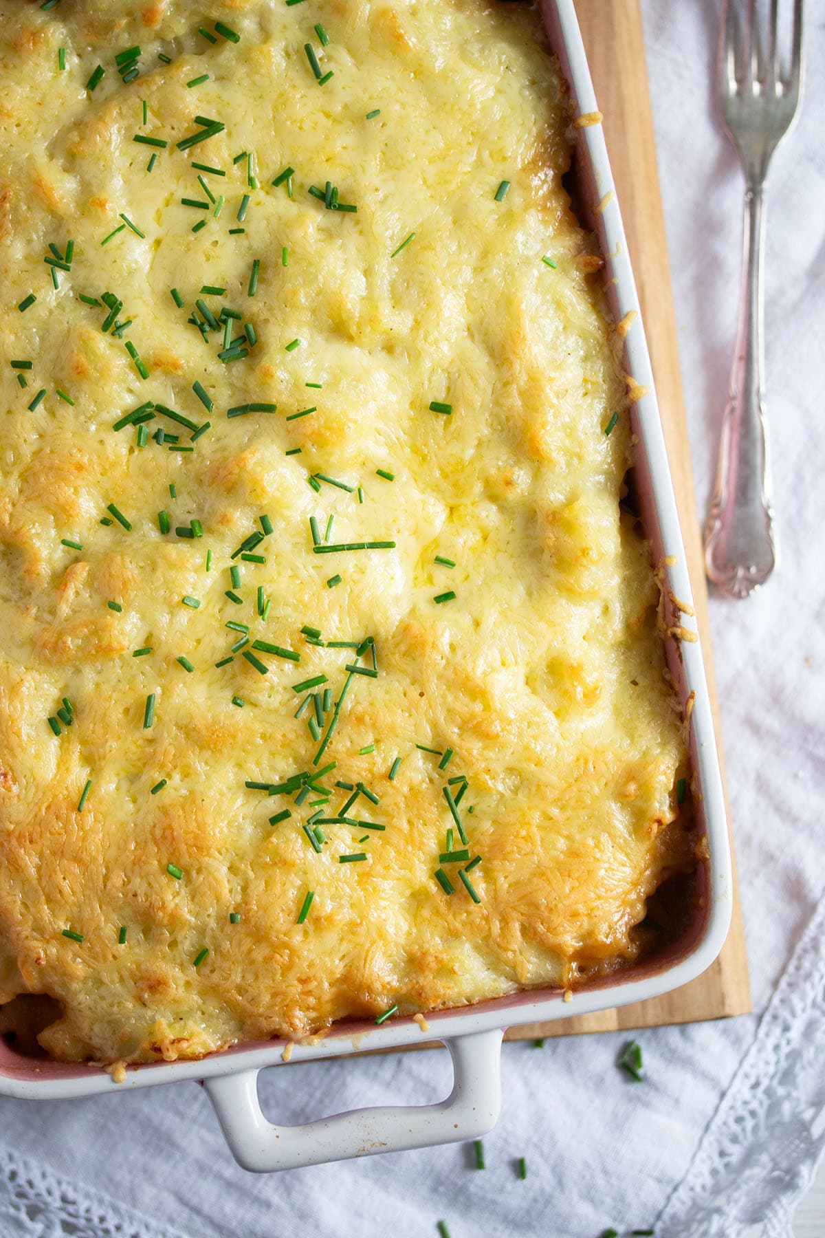 cheesy casserole with savy cabbage and potatoes in a dish.