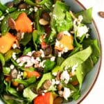 pinterest image with title of a bowl with roasted pumpkin salad.