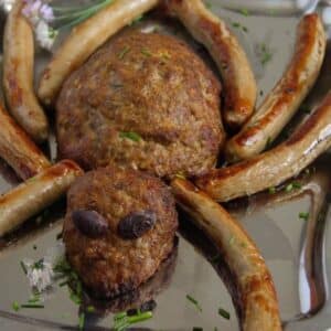 spider meatloaf with sausage legs and olive eyes for halloween.