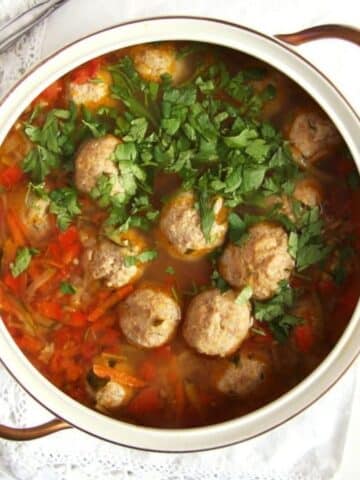 turkey meatball vegetable soup in a vintage soup pot with golden handles.