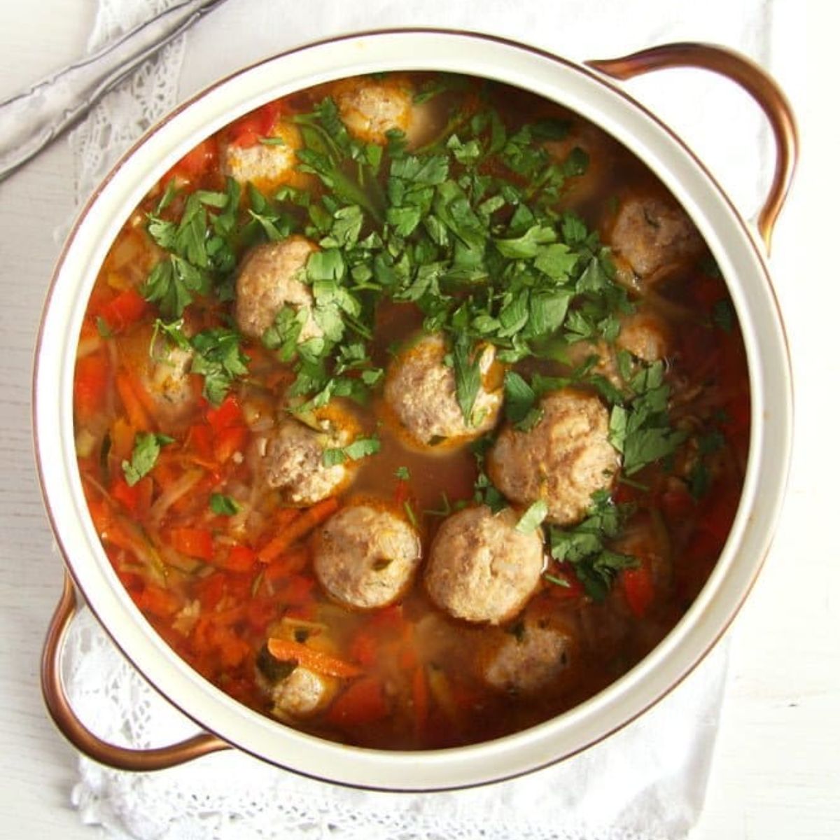 turkey meatball vegetable soup in a vintage soup pot with golden handles.