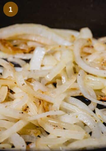 sauteing onion slices in a pan close up.