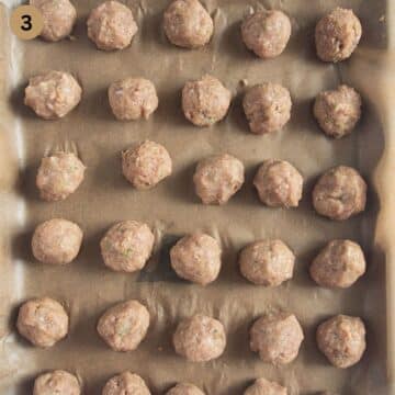 unbaked turkey meatballs for curry on a baking tray.