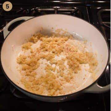 sauteing onions for making curry in a large dutch oven.