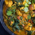 pinterest image with the title healthy chicken saag.