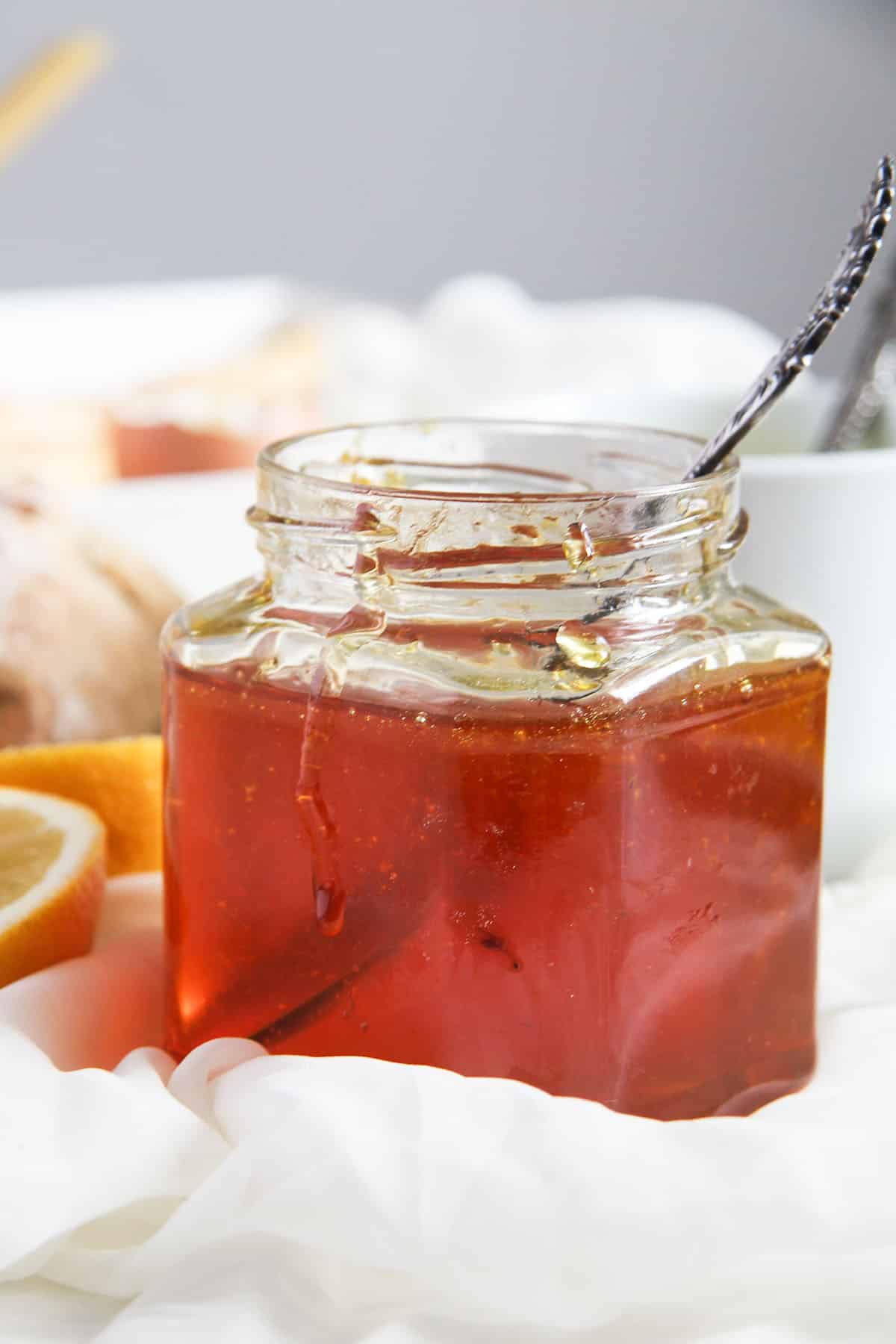 lemon jelly in a small jar with a spoon in it.
