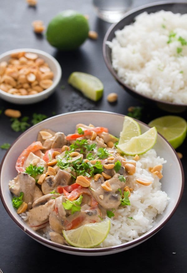 chicken in peanut butter sauce with rice and limes