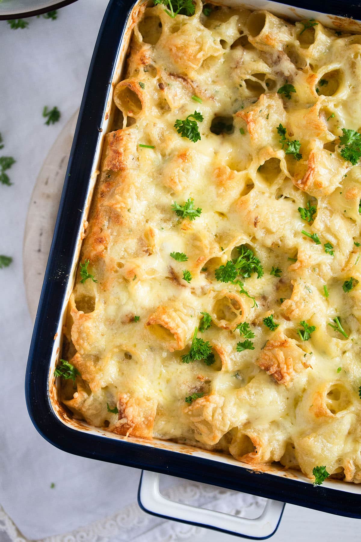pasta turkey bake in a casserole dish sprinkled with parsley.