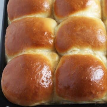 golden and shiny yeast rolls made from scratch.