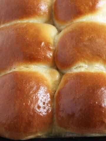 golden and shiny yeast rolls made from scratch.