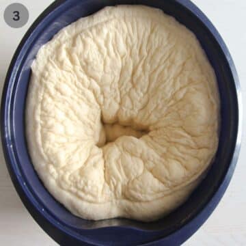 punched down yeast dough for making rolls in a bowl.