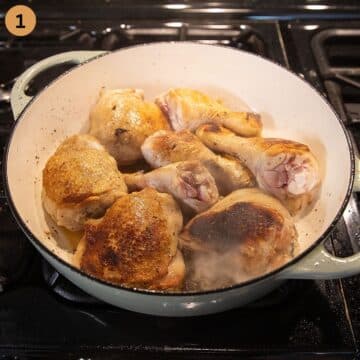searing chicken leg pieces in a dutch oven for making polenta chicken.