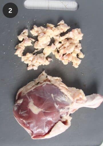 removing the excess fat from the underside of a duck leg.