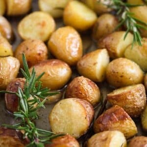 confit potatoes and two rosemary sprigs on top of them.