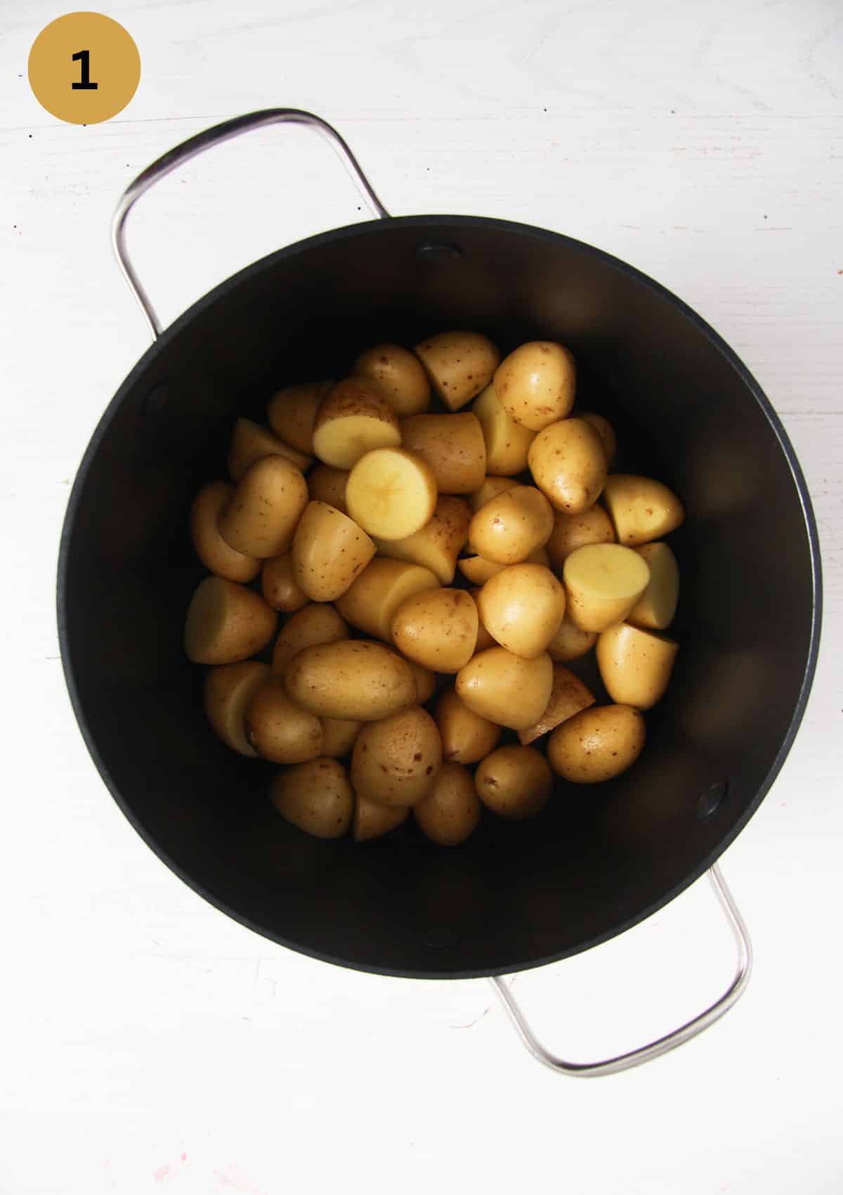 halved small potatoes in a cooking pot.