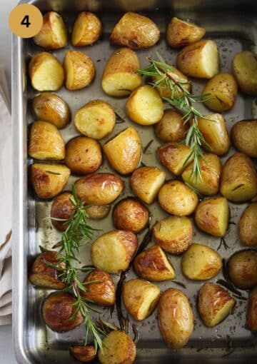 golden roasted halved small potatoes and sprigs of rosemary on top.