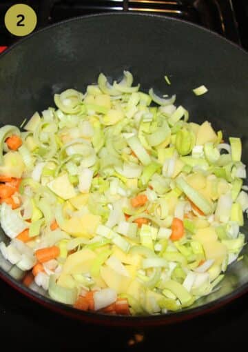 sauteing vegetables in a a soup pot.