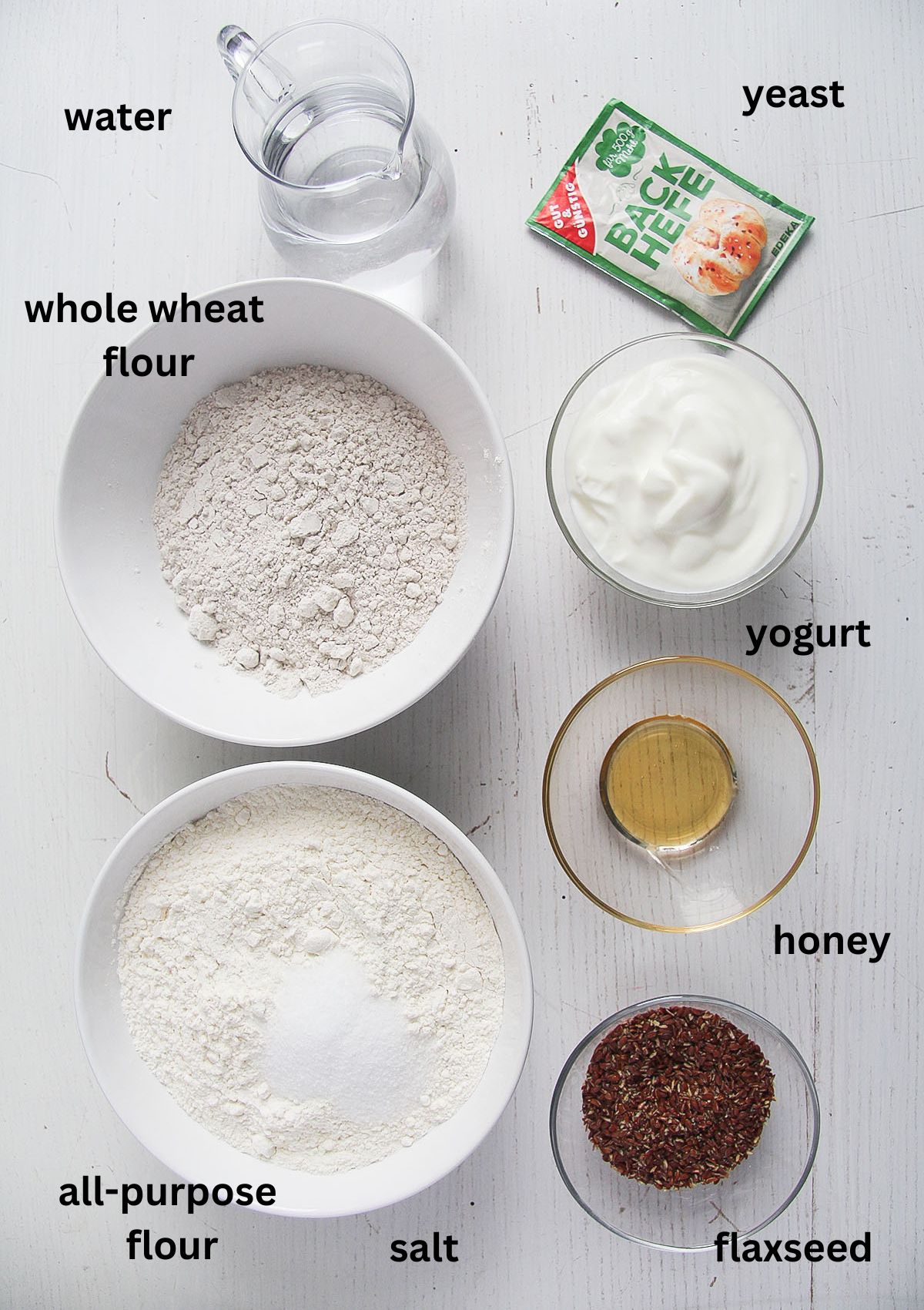 labeled ingredients for making bread with flaxseeds, yogurt, honey and yeast. 