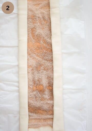 rolling puff pastry from both sides to form a log.