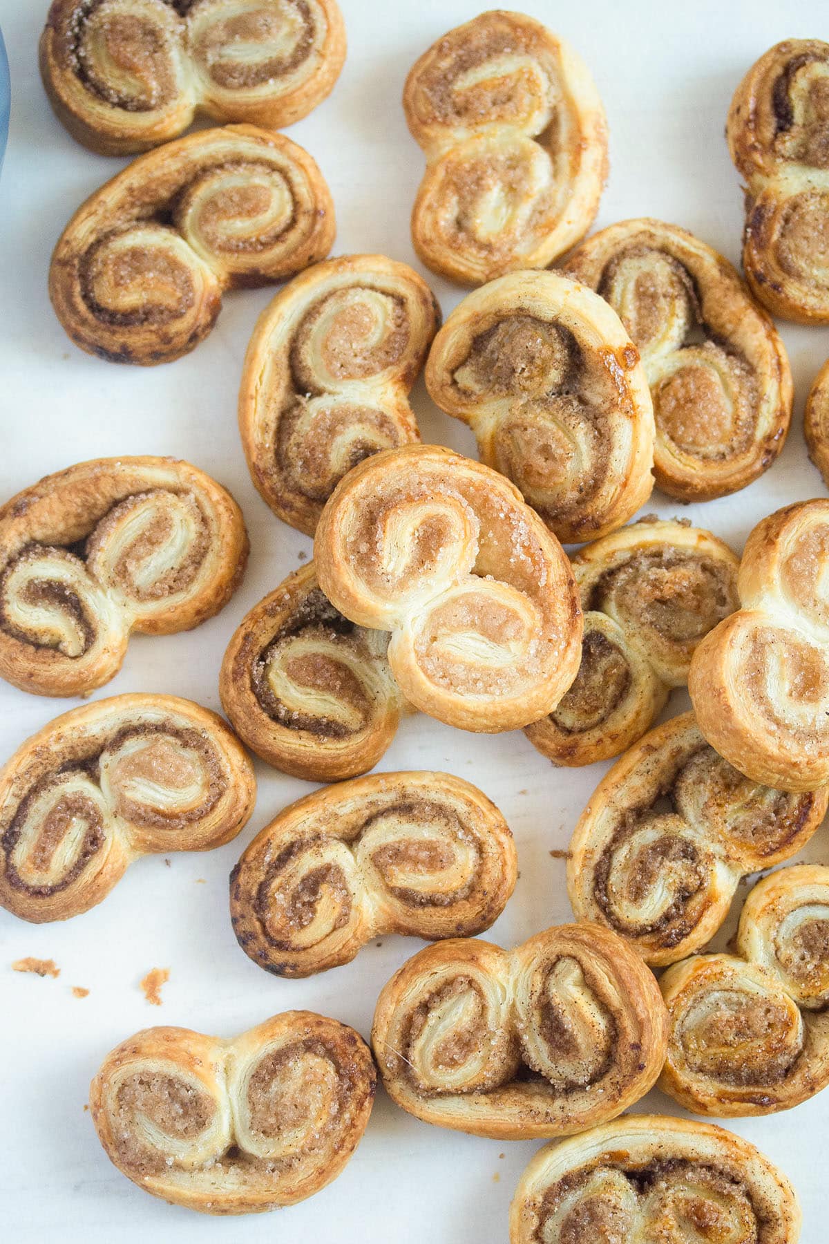 french heart cookies with cinnamon and sugar piled on the table.