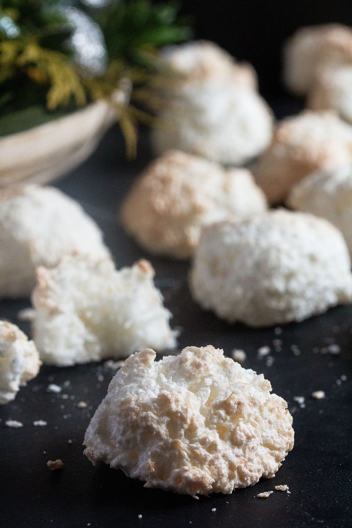 small white coconut macaroons on a dark background.