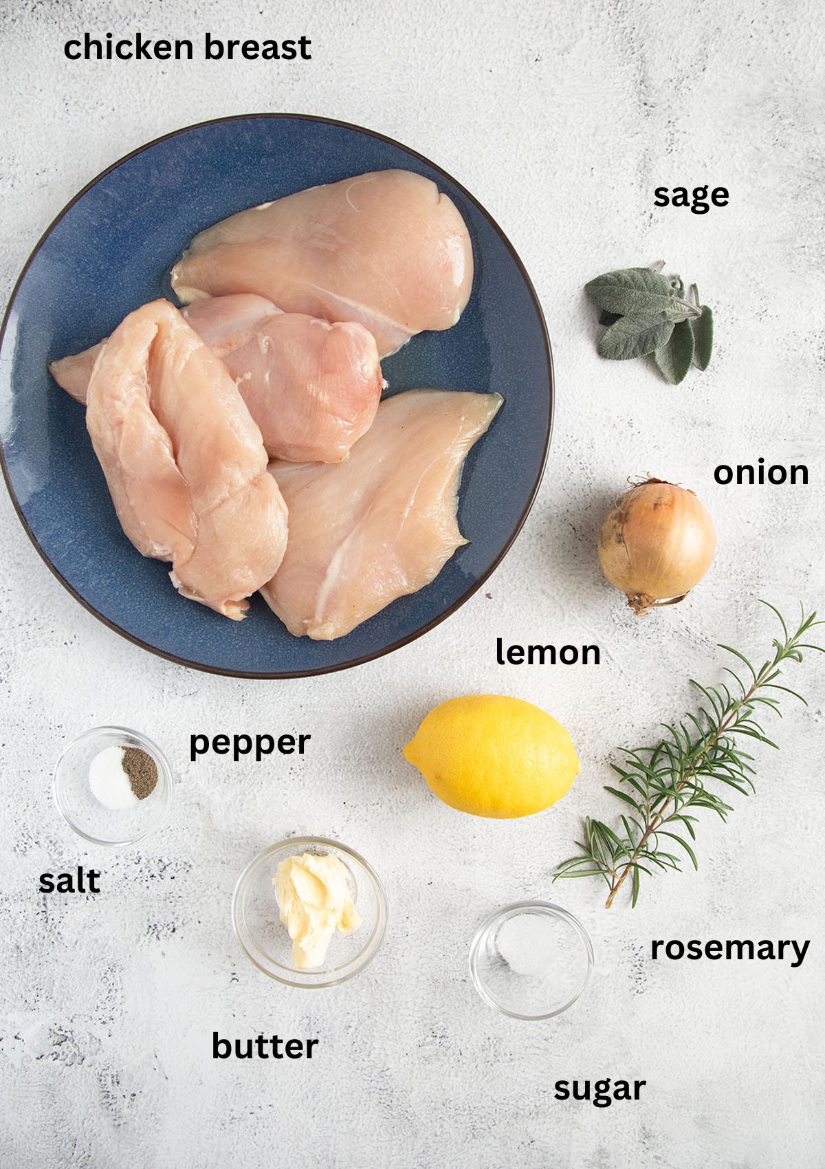 labeled ingredients for making italian chicken with herbs on the table.