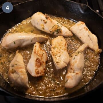 chicken breast pieces cooking in lemon sauce in a skillet.